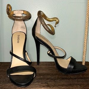 Bebe Sameena Snake ankle cuff heel in black and gold
